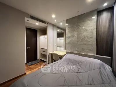 Modern bedroom with stylish decor and built-in closet, featuring elegant lighting and a cozy atmosphere.