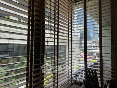 Modern apartment balcony with city view through stylish blinds