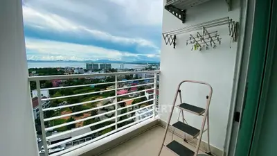 Stunning balcony view with cityscape and ocean horizon, perfect for relaxation.
