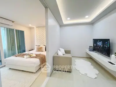 Modern studio apartment with cozy bedroom and stylish living area, featuring elegant decor and natural light.