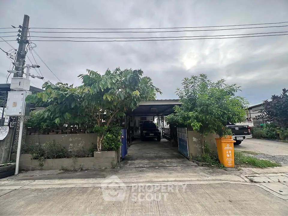 Charming suburban home with driveway and lush greenery, perfect for family living.