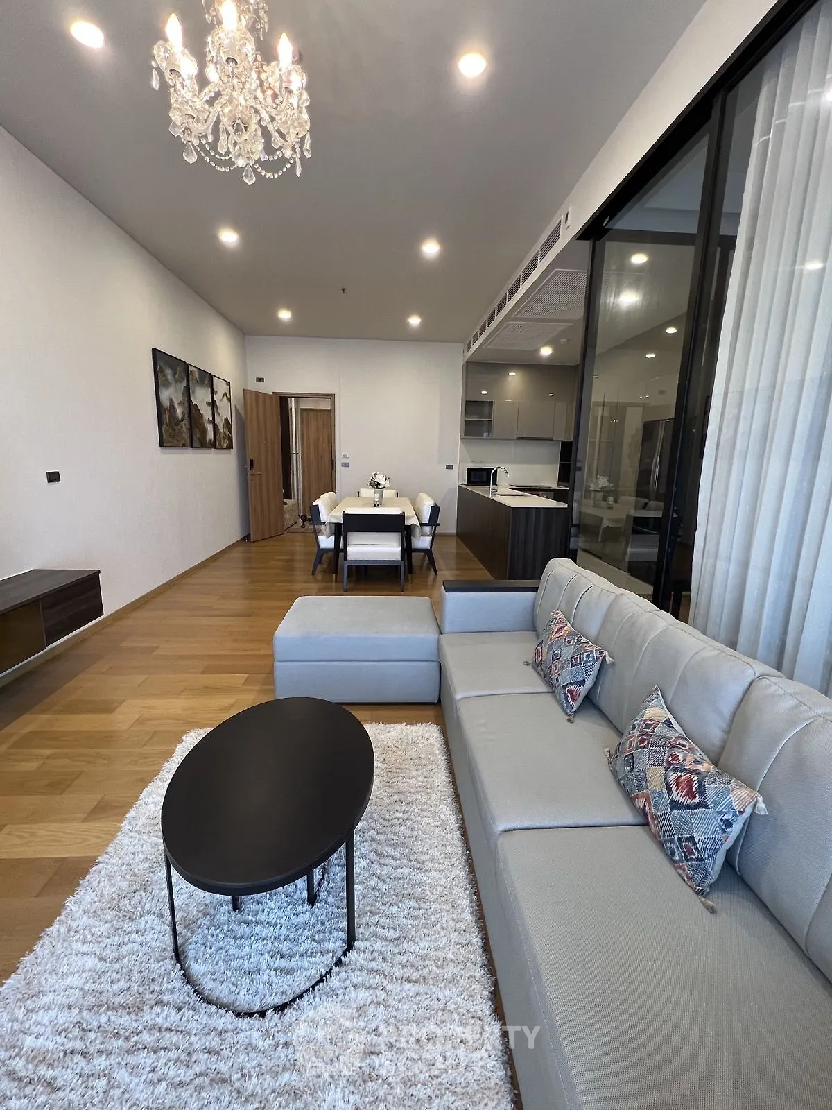Modern living room with elegant chandelier and open layout