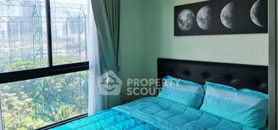 Cozy bedroom with city view and modern decor, featuring a moon phase artwork above the bed.