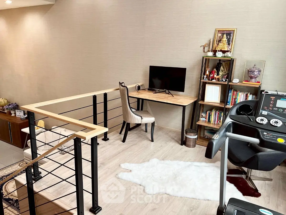 Modern home office with treadmill and stylish decor in open loft space