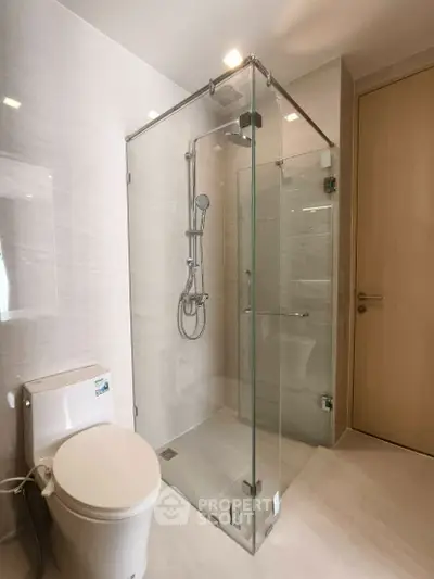Modern bathroom with glass shower enclosure and sleek fixtures