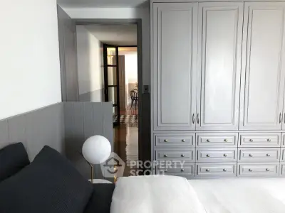 Stylish bedroom with modern wardrobe and cozy decor in a contemporary apartment.
