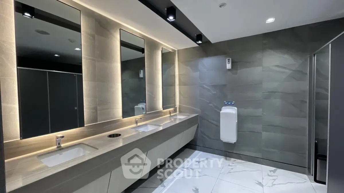 Modern commercial bathroom with sleek design and ample lighting