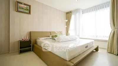 Bright and cozy bedroom with large windows and modern decor