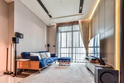 Modern living room with stylish furniture and large windows offering ample natural light.