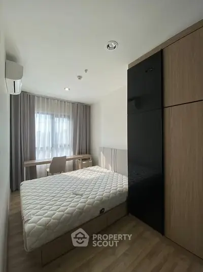 Modern bedroom with natural light, sleek furniture, and minimalist design in a stylish apartment.