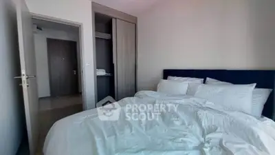Cozy bedroom with modern wardrobe and plush bedding in a stylish apartment.