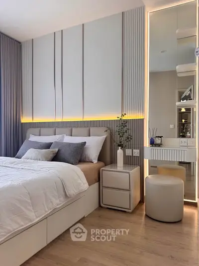 Modern bedroom with elegant design, featuring a cozy bed, stylish lighting, and contemporary decor.