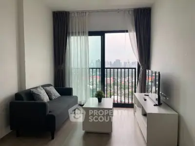 Modern living room with city view, featuring sleek furniture and large windows for natural light.