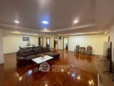 Spacious living room with elegant wooden flooring and modern furniture