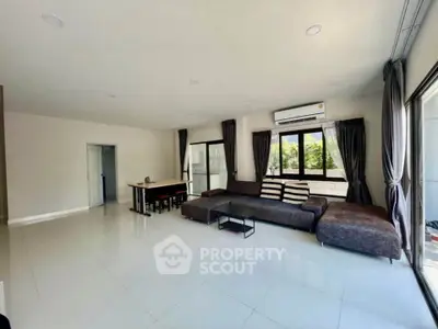 Spacious modern living room with large windows and stylish furniture