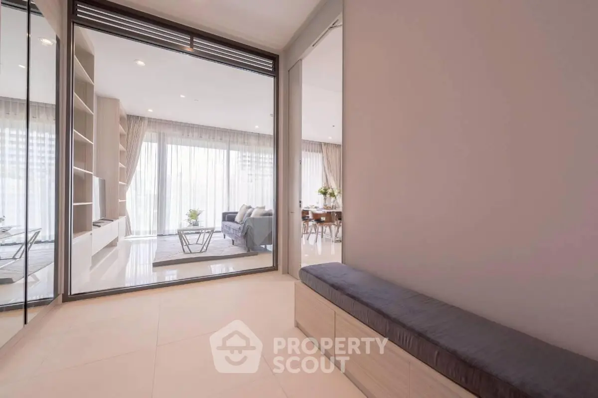 Spacious modern living room with floor-to-ceiling windows and elegant decor