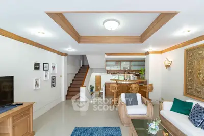 Spacious living room with elegant wooden accents and open kitchen layout