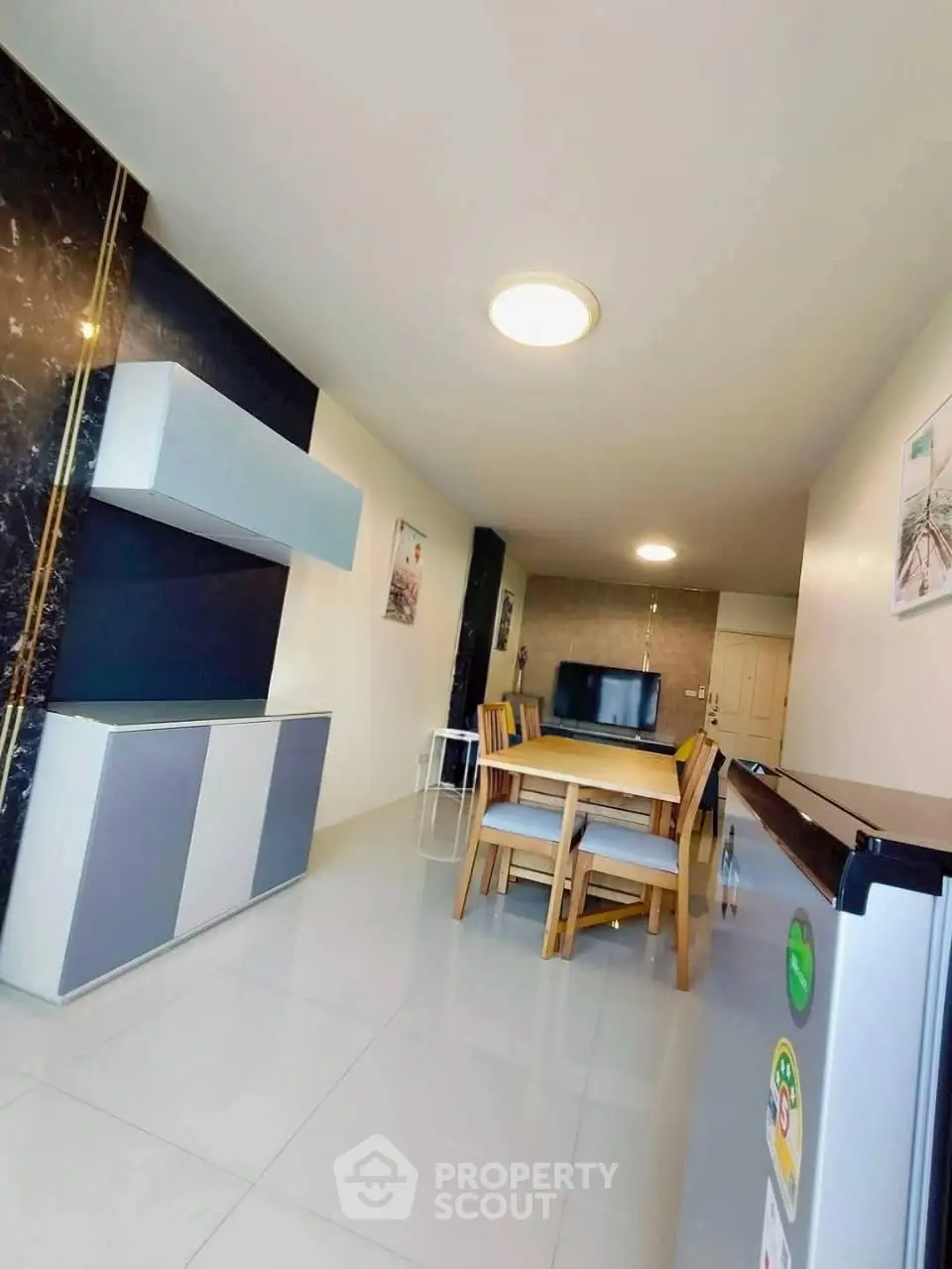 Modern dining area with sleek furniture and stylish decor in a contemporary apartment.