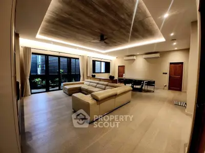 Luxurious modern living room with elegant lighting and spacious seating area.