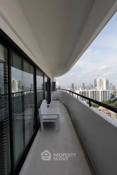 Spacious balcony with stunning city view in modern high-rise apartment