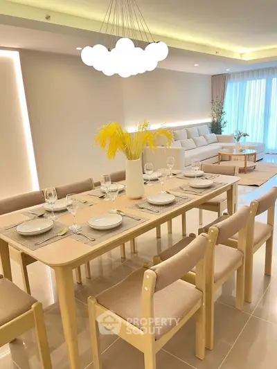 Elegant dining area with modern lighting and stylish decor in a spacious living room setting.