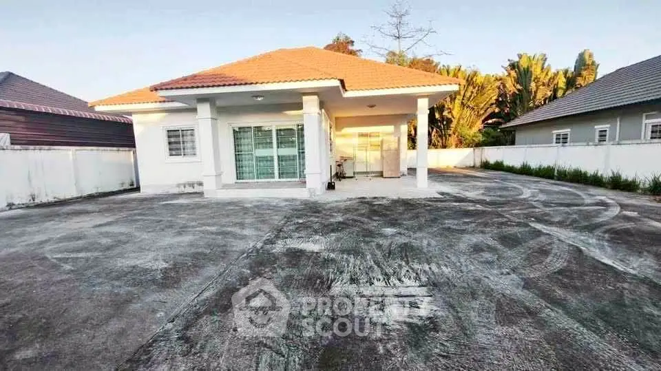 Spacious single-story house with large driveway and modern design