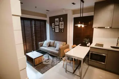 Modern living room with stylish decor and open kitchen layout in a cozy apartment.