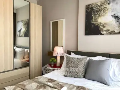 Cozy bedroom with modern decor and stylish artwork, featuring a comfortable bed and elegant lighting.
