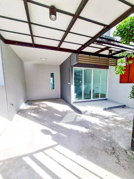 Modern covered patio with sliding glass doors and ample natural light