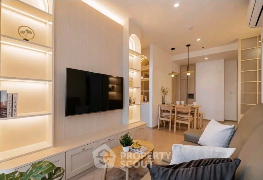 Modern living room with stylish decor and built-in shelving, featuring a cozy dining area.