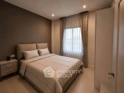 Cozy bedroom with modern decor and ample natural light