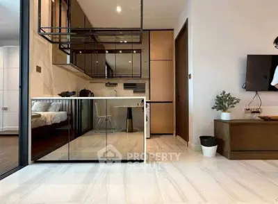 Modern apartment interior with sleek design, featuring a mirrored wall, open kitchen, and cozy living area.