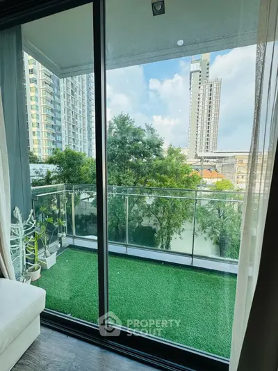 Modern balcony with artificial grass and city view, perfect for relaxation.