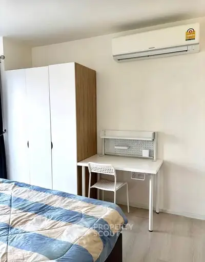 Modern bedroom with study area and air conditioning, perfect for comfort and productivity.