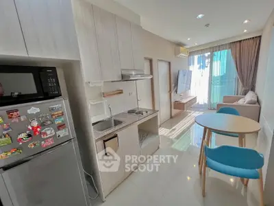 Modern open-layout kitchen and living room with natural light and stylish decor