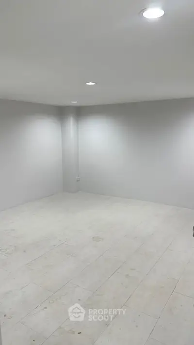 Spacious empty room with white walls and tiled floor, ideal for customization.