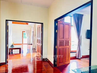 Spacious living area with wooden floors and elegant decor