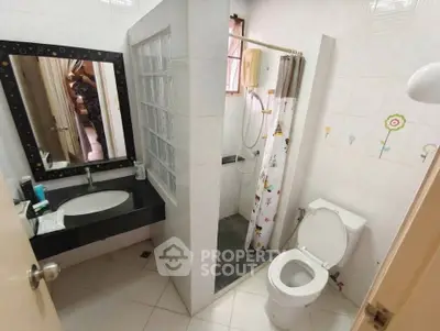Cozy bathroom with modern shower and stylish vanity in a well-lit space.