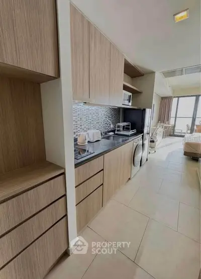 Modern kitchen with sleek cabinetry and appliances in a stylish apartment
