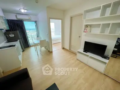 Modern apartment interior with open kitchen and cozy living area, featuring a scenic city view.