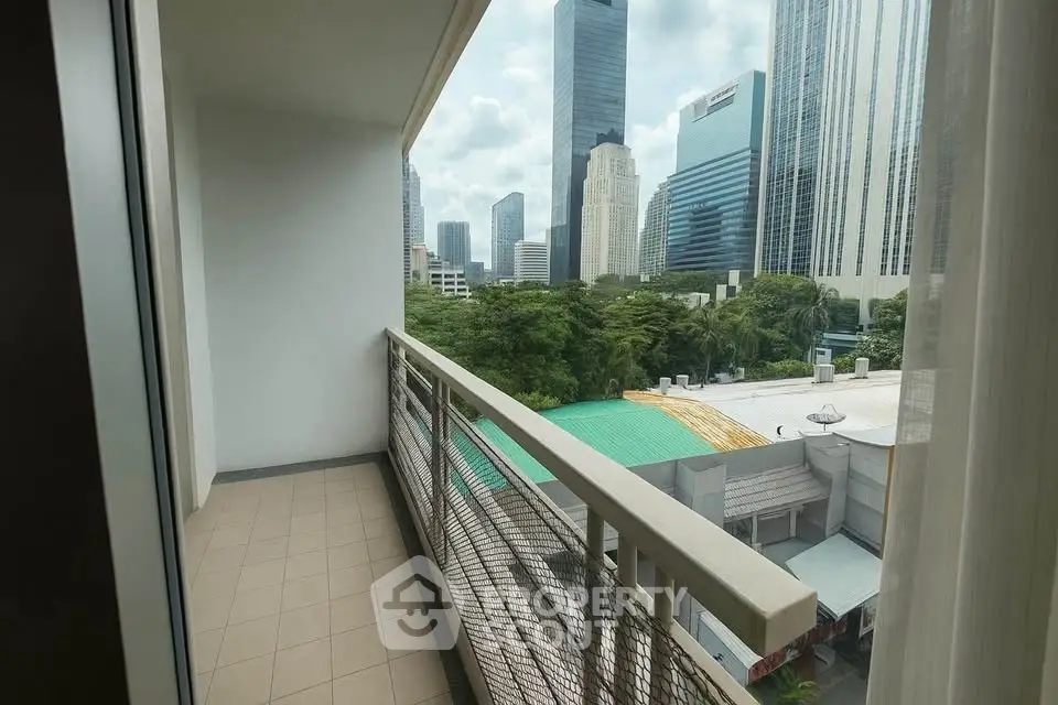Spacious balcony with city skyline view, perfect for urban living.