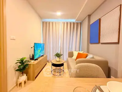 Modern living room with cozy sofa, stylish decor, and natural light through large window.