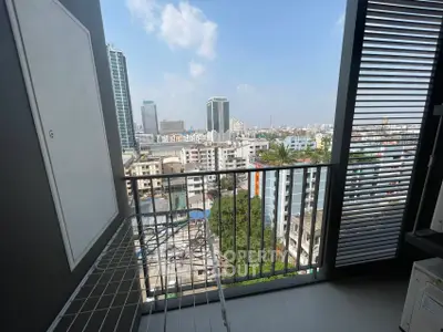 Stunning city view from modern balcony with sleek railing and urban skyline.