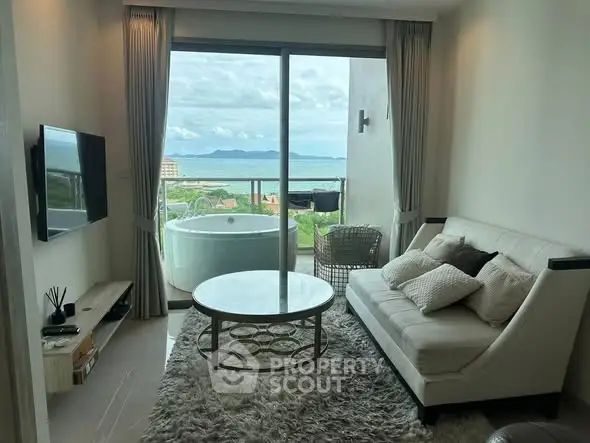 Luxurious living room with stunning ocean view and private balcony jacuzzi.