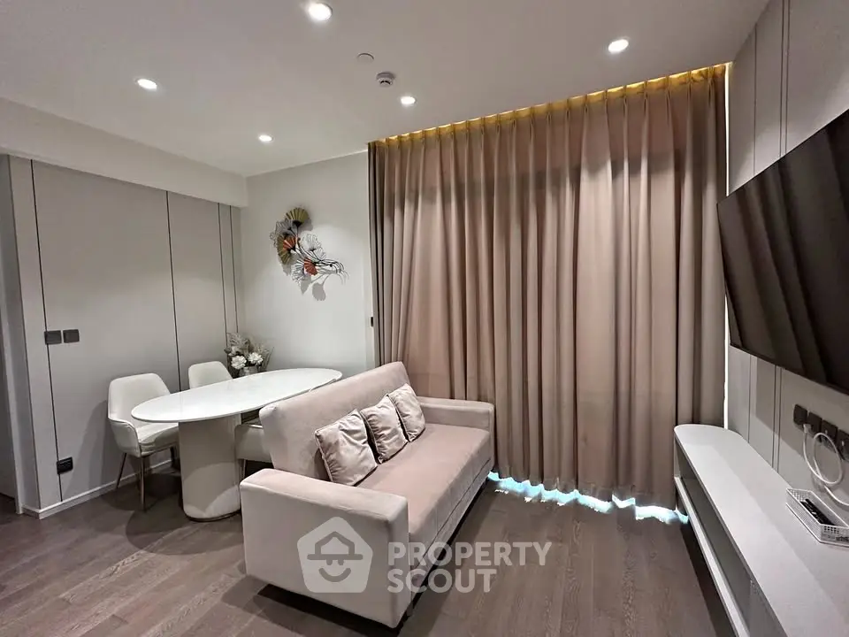 Modern living room with sleek furniture and elegant decor, featuring a cozy sofa and dining area.