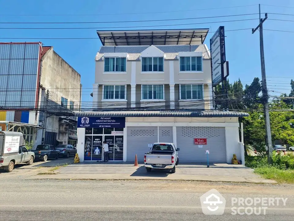 Modern commercial building with parking space and street view