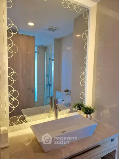 Elegant bathroom with modern sink and decorative mirror