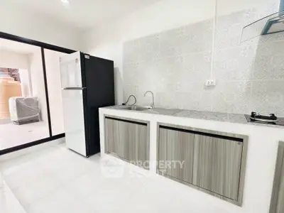 Modern kitchen with sleek cabinetry and gas stove in a bright, open layout.