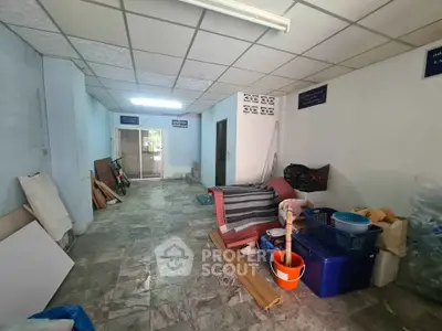 Spacious storage area with tiled flooring and ample natural light, ideal for organizing and storing belongings.