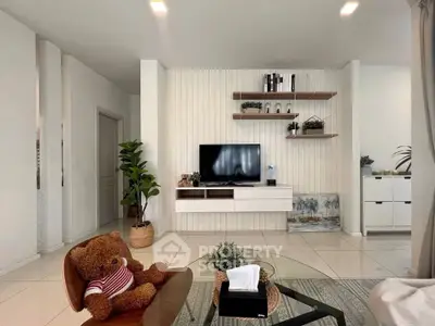 Modern living room with stylish decor and wall-mounted TV, featuring cozy seating and indoor plants.
